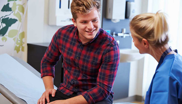 A young man consults with a provider